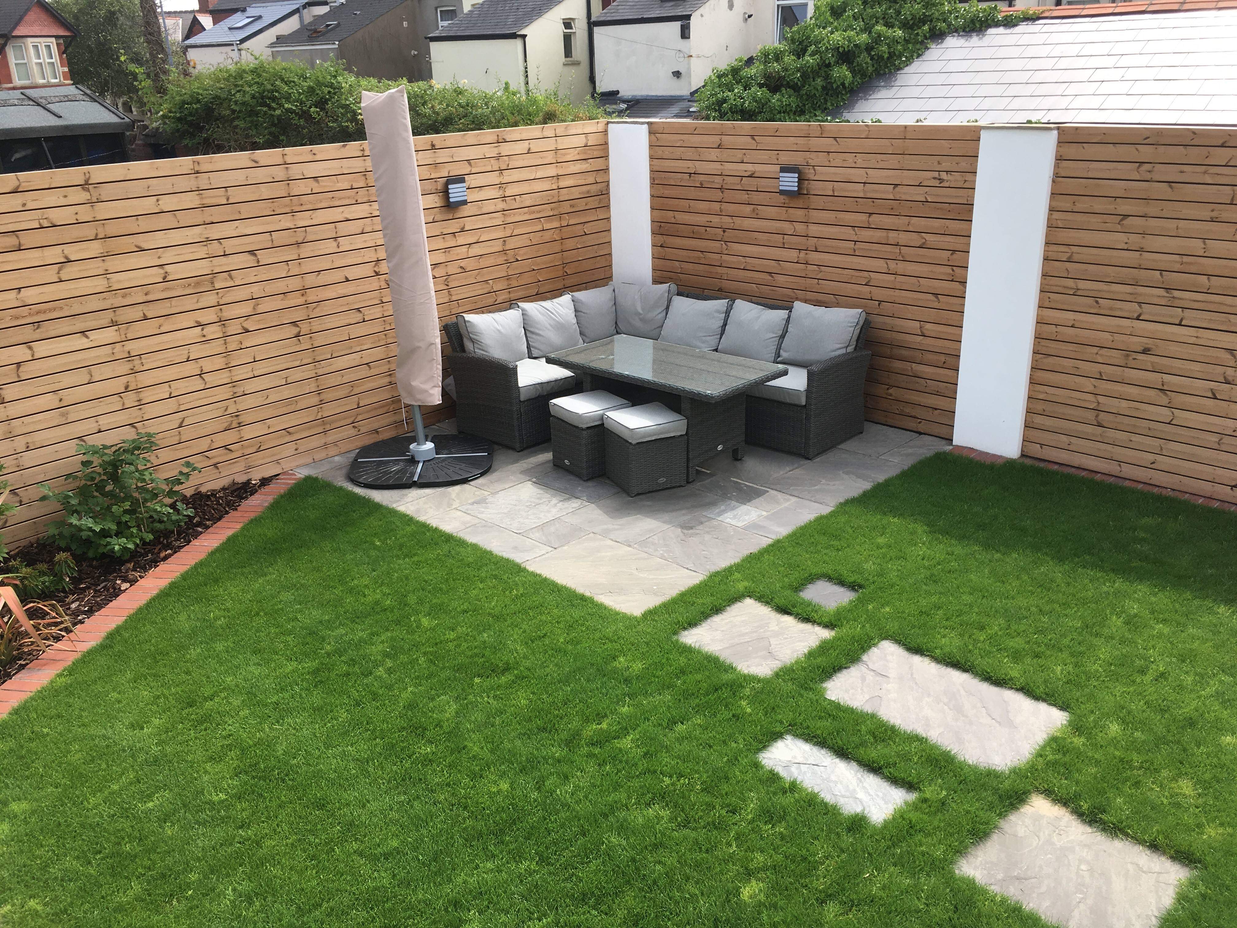 After: finished modern garden with porcelain paving, lounge corner and thermowood cladding at Amesbury Road