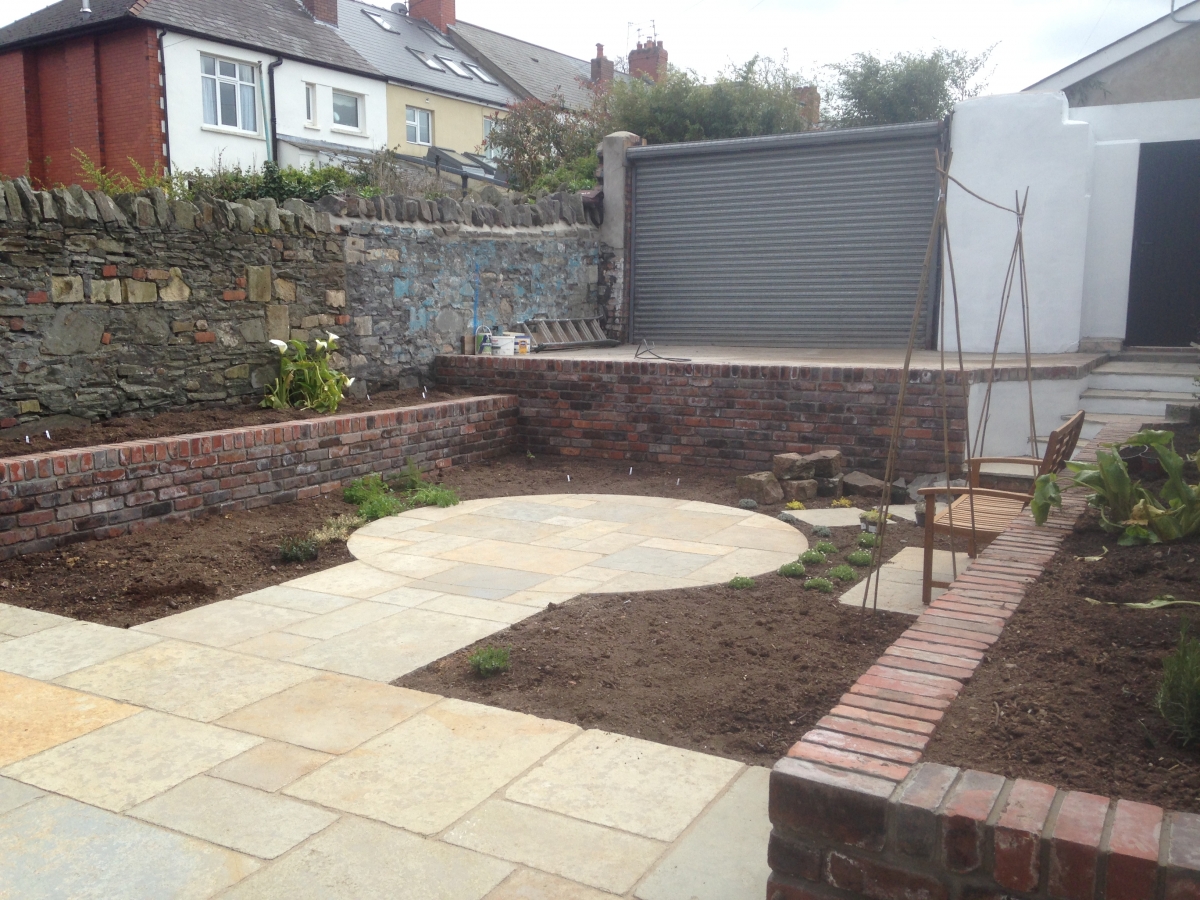 After: the completed circular patio from the house, showing the new level lawn area
