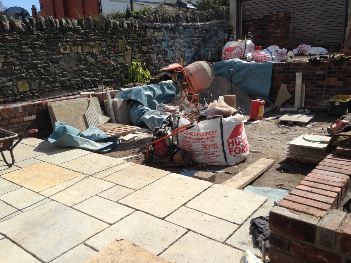 During: new stone walling under construction across the rear boundary