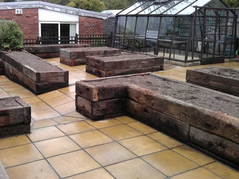 Oak sleeper planters freshly built on a commercial grounds contract.