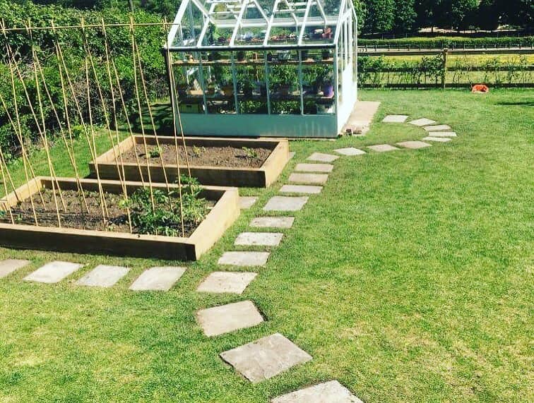 Rudry: a kitchen garden with greenhouse, raised beds and a stepping-stone path.