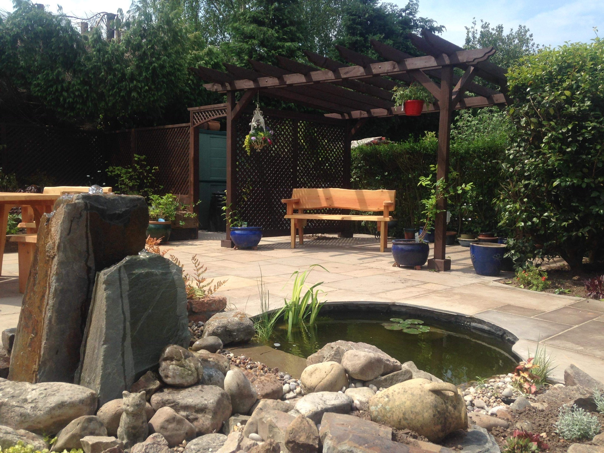 Completed garden with natural stone pond, water feature and timber pergola seating area